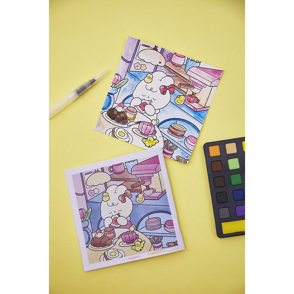 Fertiges Aquarellbild neben Farbpalette und Pinsel